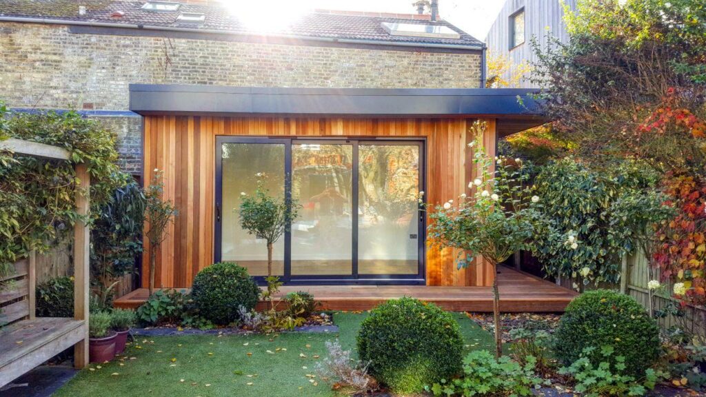 Stylish, contemporary garden room used as garden gym with extra height and cedar cladding in London