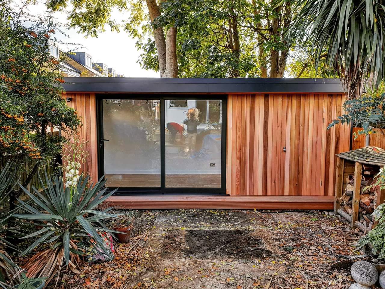 A bespoke cedar-clad garden room with a hidden shed, in Wimbledon