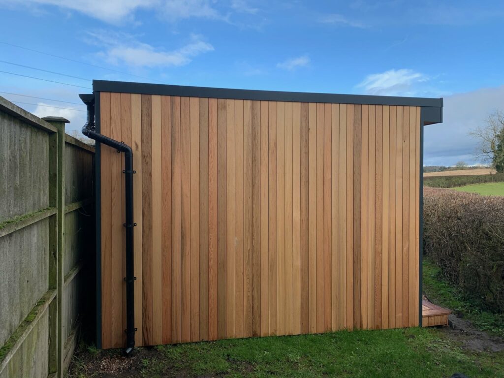 Cedar clad garden room with guttering and downpipes