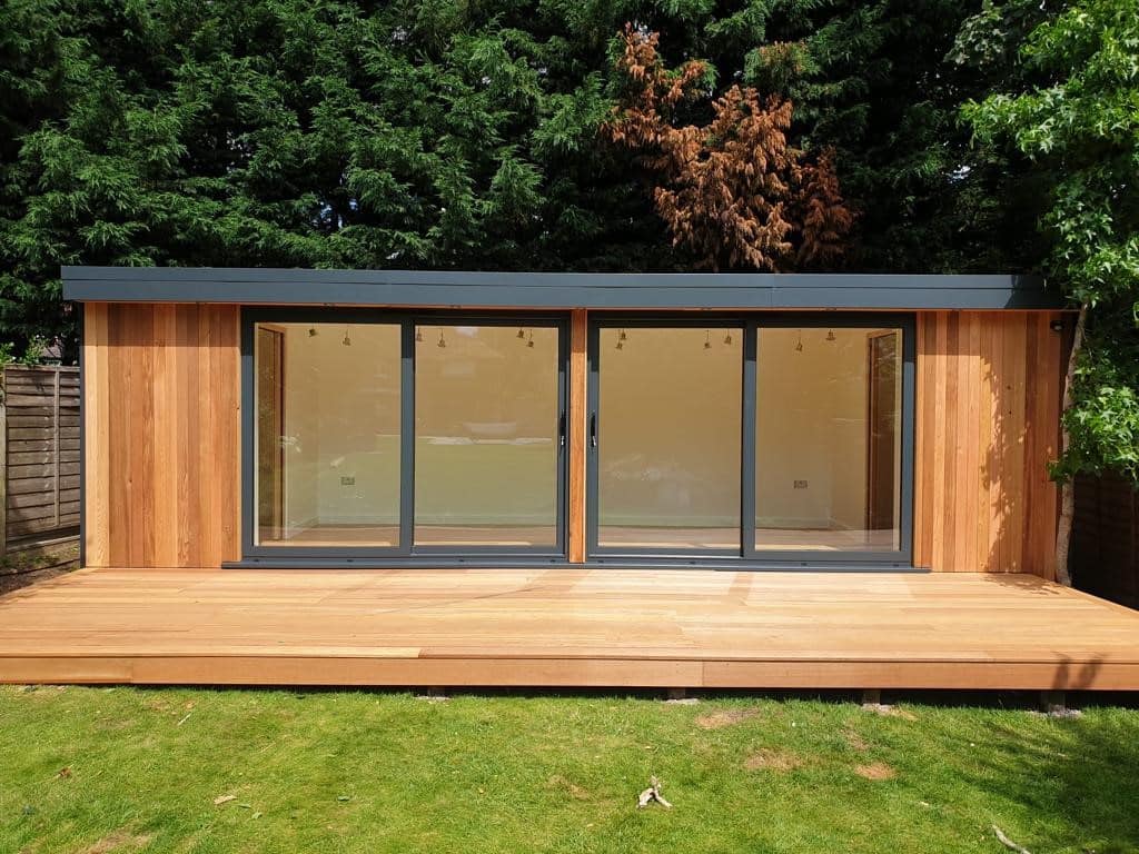 Garden room with double doors and large decking in st albans